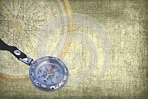 Classic round compass on background of old vintage map of world