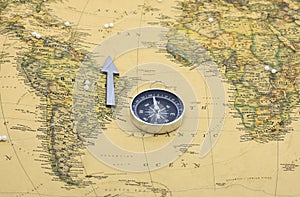 Classic round compass on background of old vintage map of world