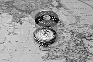 Classic round compass on old vintage map depicting North America and the United States of America as symbol of tourism with compas