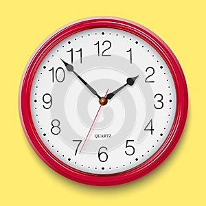 Classic round wall clock with red glossy body isolated on bright yellow background