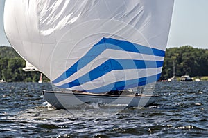 Classic sailing yacht with spinnaker on a lake in a regatta