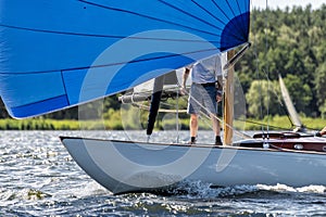 Classic sailing yacht with spinnaker on a lake in a regatta