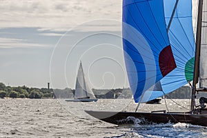 Classic sailing yacht with spinnaker on a lake in a regatta