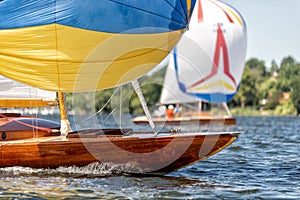 Classic sailing yacht with spinnaker on a lake in a regatta