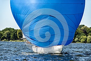 Classic sailing yacht with spinnaker on a lake in a regatta