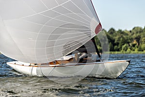 Classic sailing yacht with spinnaker on a lake in a regatta