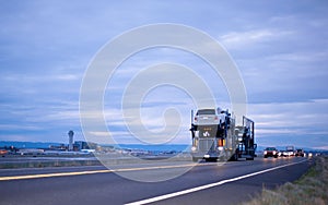 Classic semi truck car hauler stylish in column on night road be