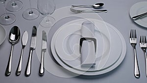 Classic serving tableware on the table, white plate fork and knife