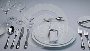 Classic serving tableware on the table, white plate fork and knife.