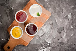 Classic set of sauces in white saucers photo