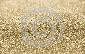 Classic shiny gold glitter background with selective focus