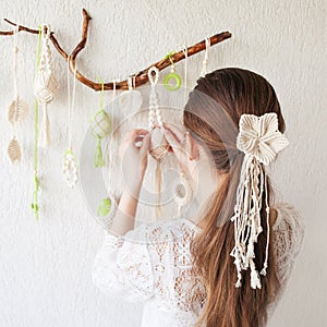 Classic, simple and elegant hairstyle with stylish hair accessory, rear view. Little girl back hairstyle view. Macrame flower