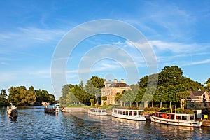 Classic small cruise boats on the famous Dutch river Vecht