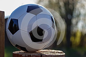 Classic soccer ball in the backlight, sunlight on a beautiful bokeh background