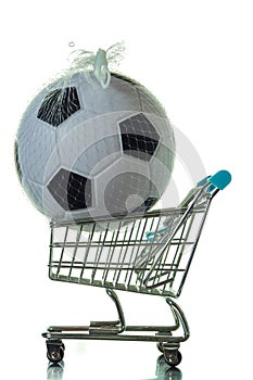 Classic soccer or football ball and shopping cart. Selling and buying sport equipment concept. White background. Sport supply