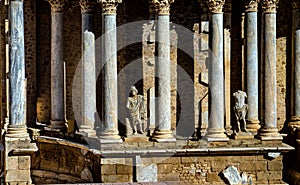 Classic statues without heads and Greek and Roman columns from the Roman Theater of Merida in Extremadura, illuminated by the