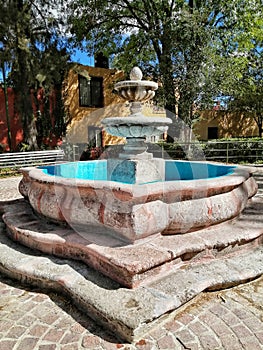 Classic stone fountain with morning light at guadiana park san miguel de allende