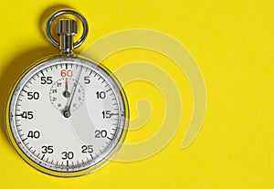 Classic stopwatch on a yellow background