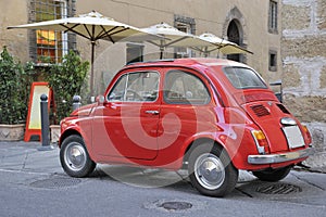 Classic streetscene with red fiat car