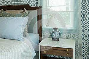 Classic style bedroom with blue pillows and chinese lamp style