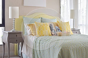 Classic style bedside table with reading lamp next to cozy style bedding