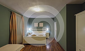 Hotel bedroom classic style interior, cosy night atmosphere photo
