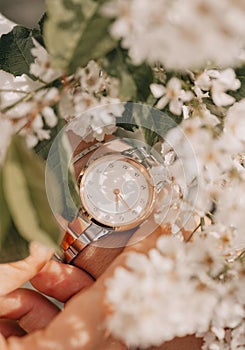 Classic stylish white watch on woman hand. Close-up photo