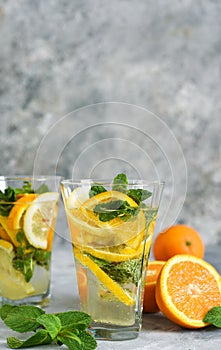 Classic summer cold drink - lemonade with orange, lemon and mint