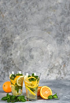 Classic summer cold drink - lemonade with orange, lemon and mint