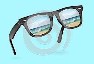 Classic sunglasses with reflection of sea isolated on blue background