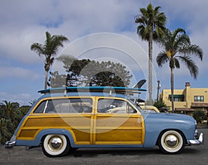 Classic surfer woody car with surfboard, near Encinitas CA