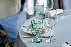 Classic table setting at the Banquet.Glasses of light green glass. wedding Banquet. photo