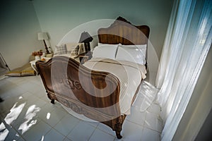 Classic teak wood bed furniture in the warm and cozy bedroom, ne