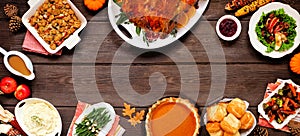 Classic Thanksgiving turkey dinner. Top view frame on a dark wood banner background.