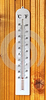 Classic thermometer on wooden board
