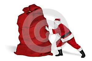 Classic traditional crazy funny santa claus on exhausting delivery service. pushing huge giant big red bag with christmas gift photo