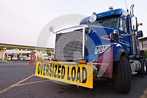 Classic truck big rig blue sign oversized load truck stop