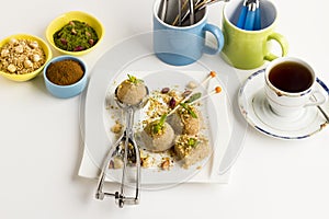 Classic Turkish Dessert,Semolina,irmik Halva,served with a cup of tea on the white surface.