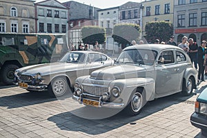 Vintage grey Swedish cars Volvo B16 and P1800 at a car show parked