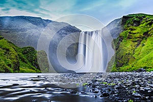 Classic view of famous Skogafoss waterfall in twilight, Iceland