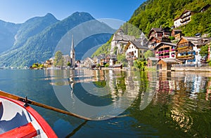 Classic view of Hallstatt with traditional rowing boat in summer, Salzkammergut region, Austria