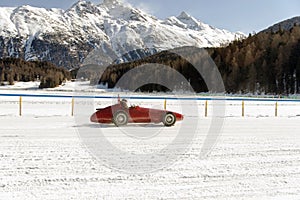 A classic vintage car on the frozen lake of St Moritz in winter