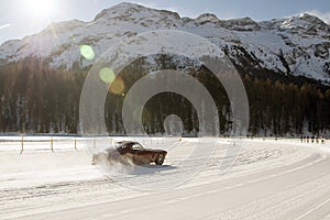 A classic vintage car on the frozen lake of St Moritz in winter