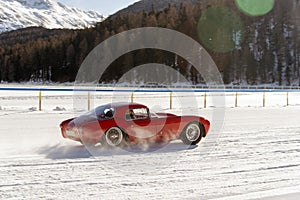 A classic vintage car on the frozen lake of St Moritz in winter