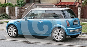 Old small blue car Mini Cooper parked left side view