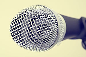 The classic vintage silver microphone on green background