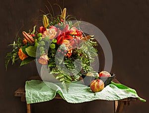 Classic vintage still life with a bouquet of flowers and apples.