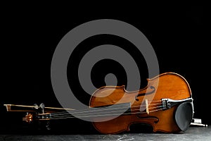 Classic violin and bow on grey table. Space for text