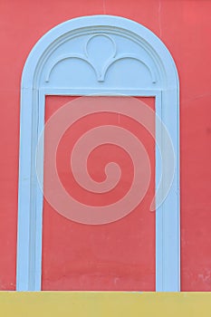 Classic white arch door pattern on the red wall background.