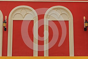 Classic white arch door pattern on the red wall background.
